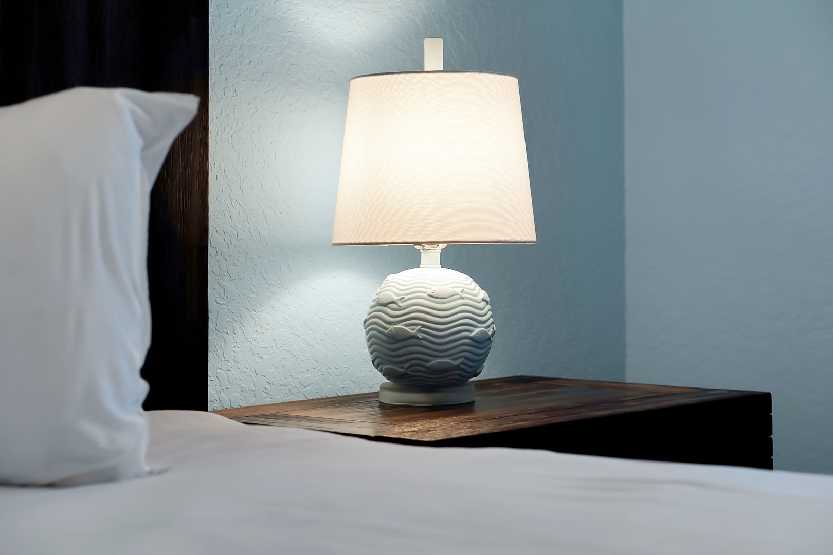 Unwind in your cozy bedroom with elegant bedside lighting that creates the perfect ambiance for evening reading.