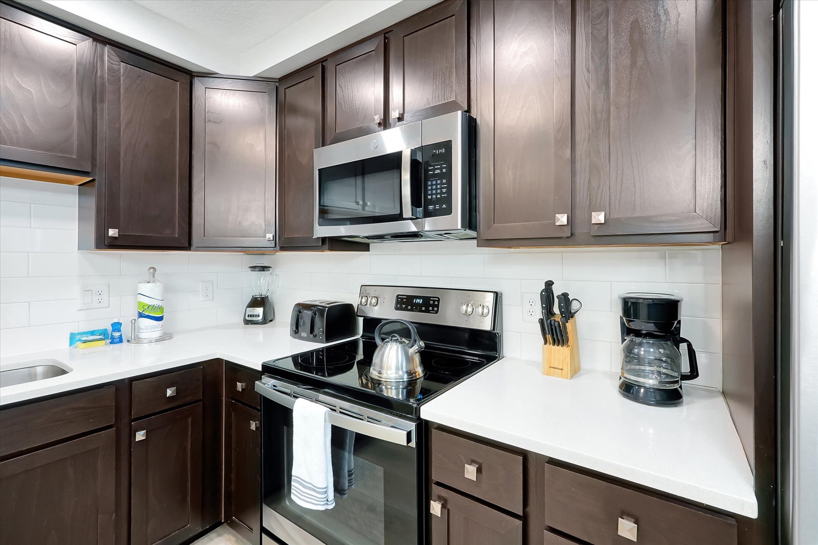 Step into your fully equipped kitchen with sleek appliances and ample storage, perfect for preparing memorable meals during your stay.