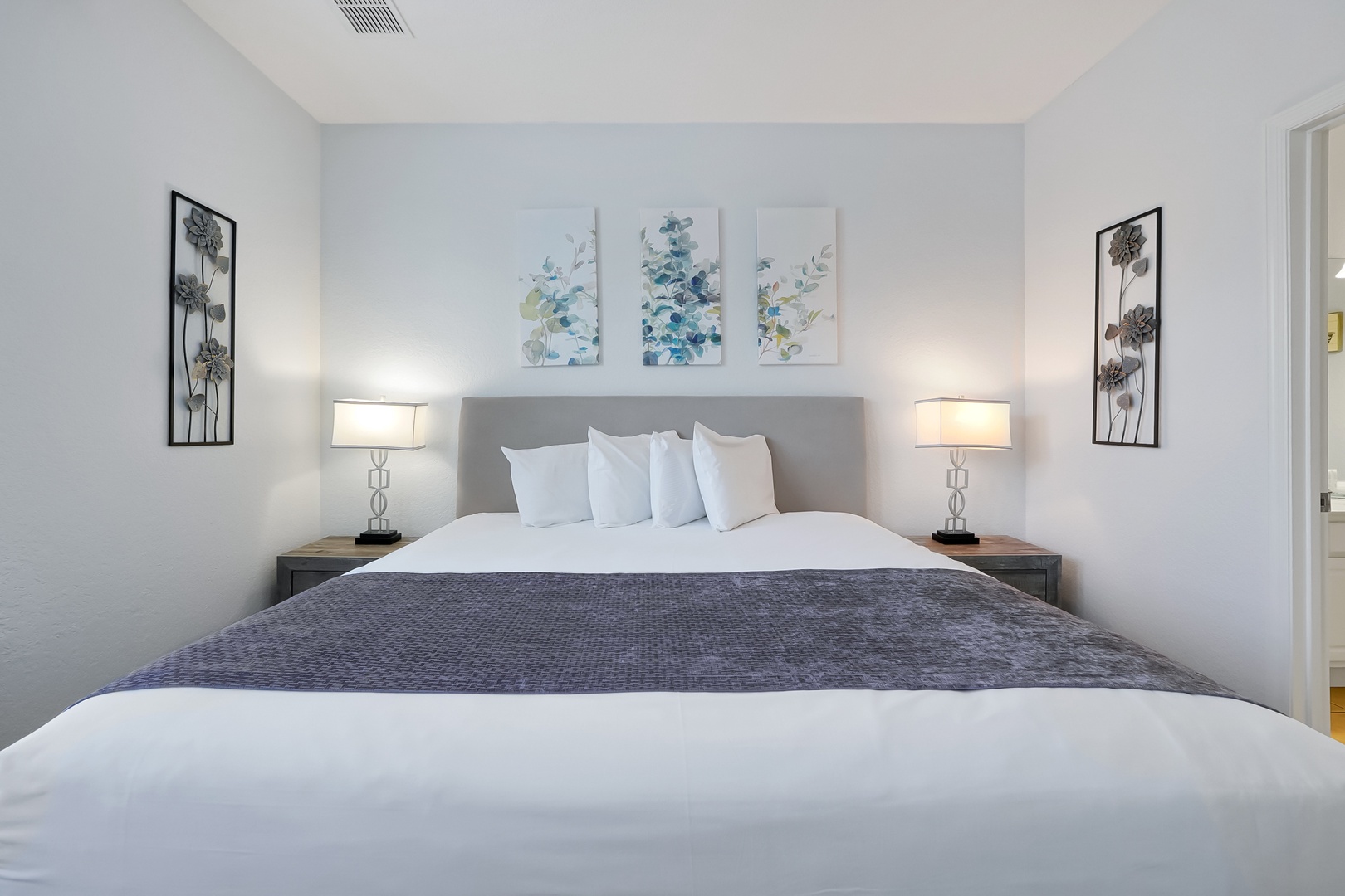Drift into peaceful sleep in your serene bedroom, featuring crisp linens and calming artwork that creates the perfect retreat.