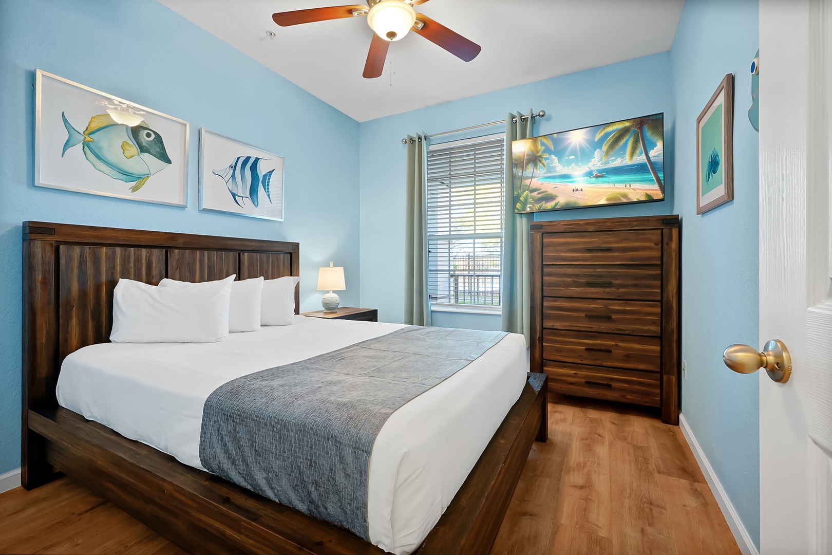 Your serene bedroom sanctuary features coastal-themed artwork and a plush bed for ultimate relaxation after beach adventures.