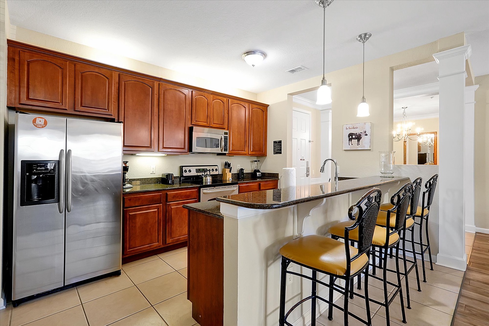 Your fully equipped kitchen features rich cherry cabinets, granite counters, and a breakfast bar where you can gather for morning coffee.