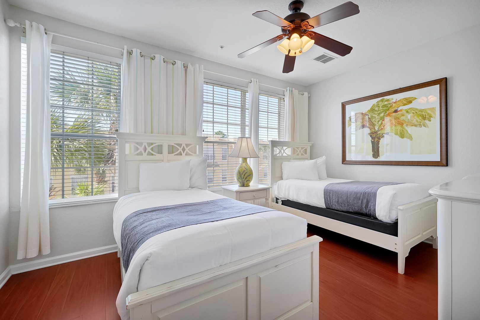 Drift off to sleep in your bright twin bedroom, where crisp linens and tropical artwork create a peaceful sanctuary.