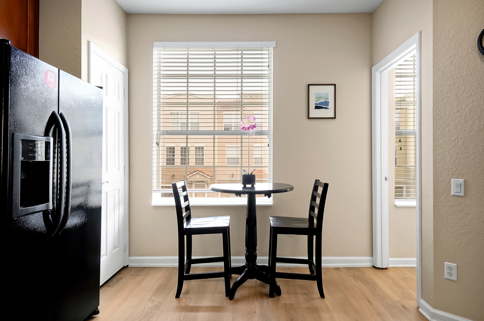 Enjoy intimate meals at your cozy dining nook with city views through bright windows and modern conveniences nearby.