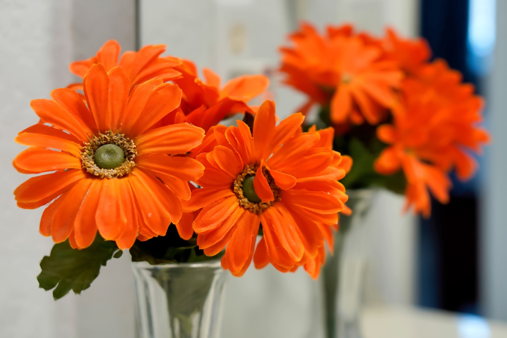 Bright orange gerbera daisies add a cheerful pop of color to your stay, creating a welcoming atmosphere in your home away from home.