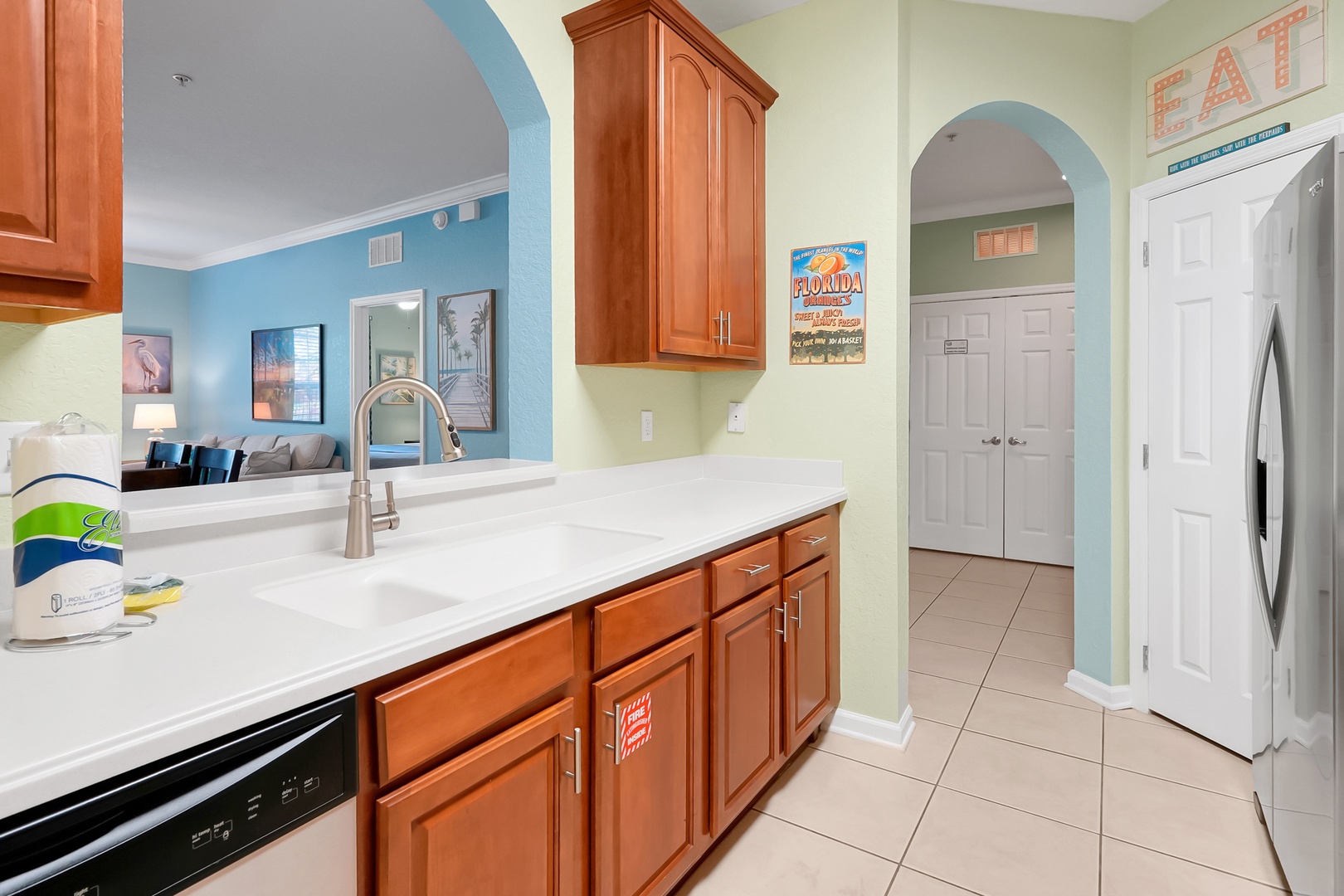 Prepare your favorite meals in this spacious kitchen featuring rich wood cabinetry, pristine countertops, and modern appliances.