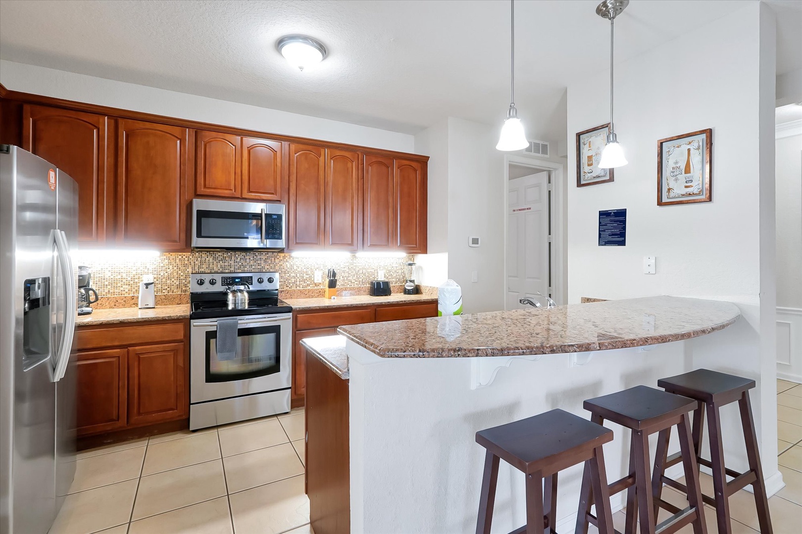 Your fully equipped kitchen features granite counters, stainless appliances, and a breakfast bar where you can enjoy morning coffee.