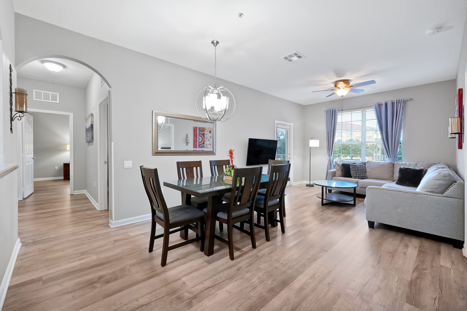 Step into this bright, open-concept space where dining and relaxation flow together seamlessly. Gather around the elegant dining table or sink into the plush sofa—your home away from home awaits.