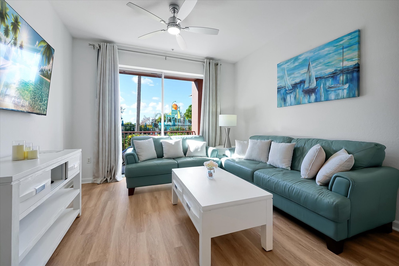 Sink into your spacious sectional sofa while gentle breezes flow through your bright living area, complete with coastal artwork and modern amenities.