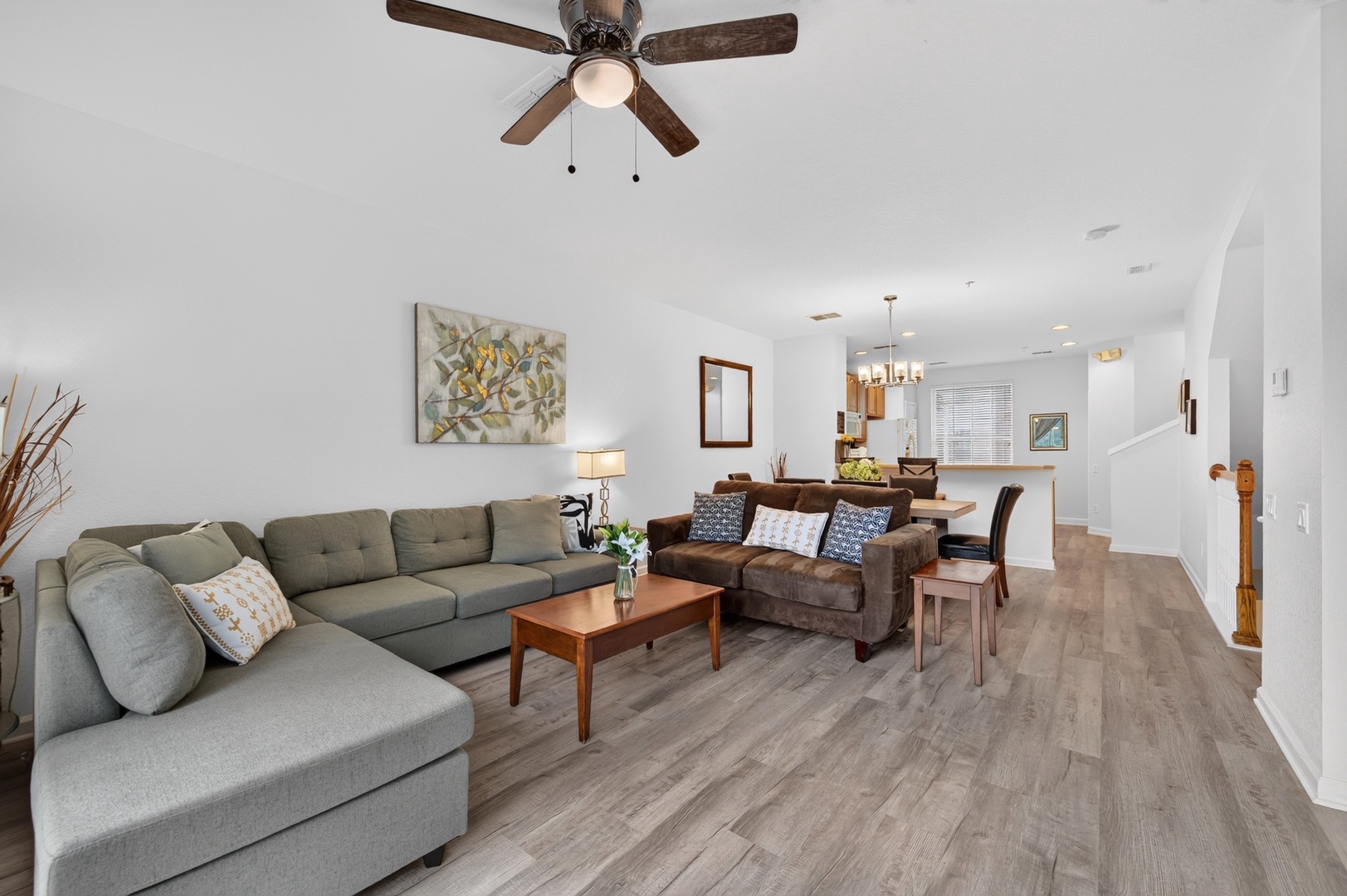 Settle into your bright, open living space where the ceiling fan cools you as you relax on plush seating. The airy layout seamlessly connects lounging and dining, making it easy to unwind or gather with loved ones.