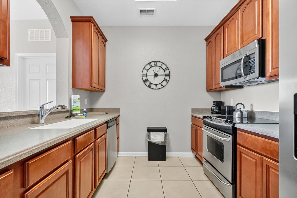 Your fully equipped kitchen features warm wood cabinetry, granite countertops, and modern appliances—perfect for preparing memorable meals during your stay.