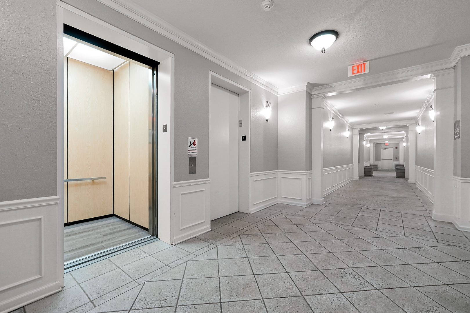 This elegant hallway leads you to your next adventure, with fresh modern design and easy elevator access for your convenience.