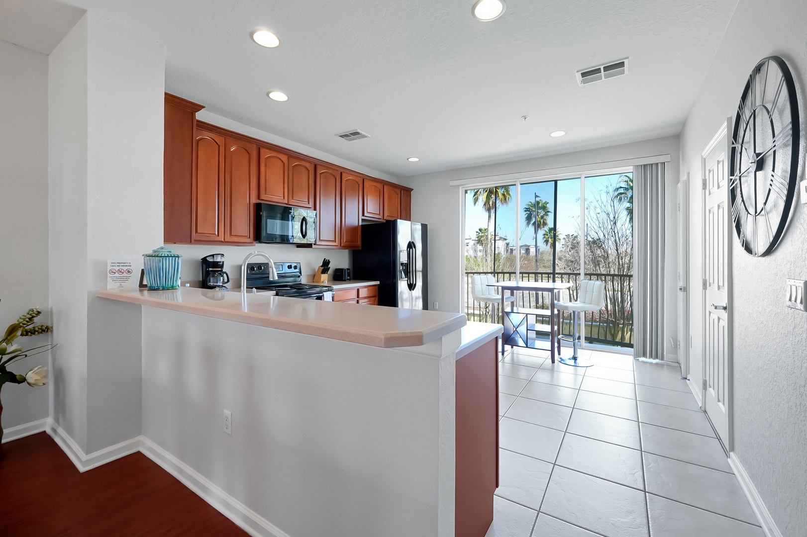 Your fully-equipped kitchen opens to a sunny balcony where you can sip morning coffee while palm trees sway outside your window.
