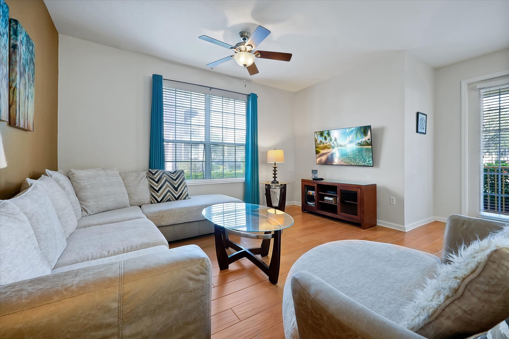 Your spacious living room awaits with plush sectional seating, perfect for unwinding while enjoying your favorite shows on the large TV.