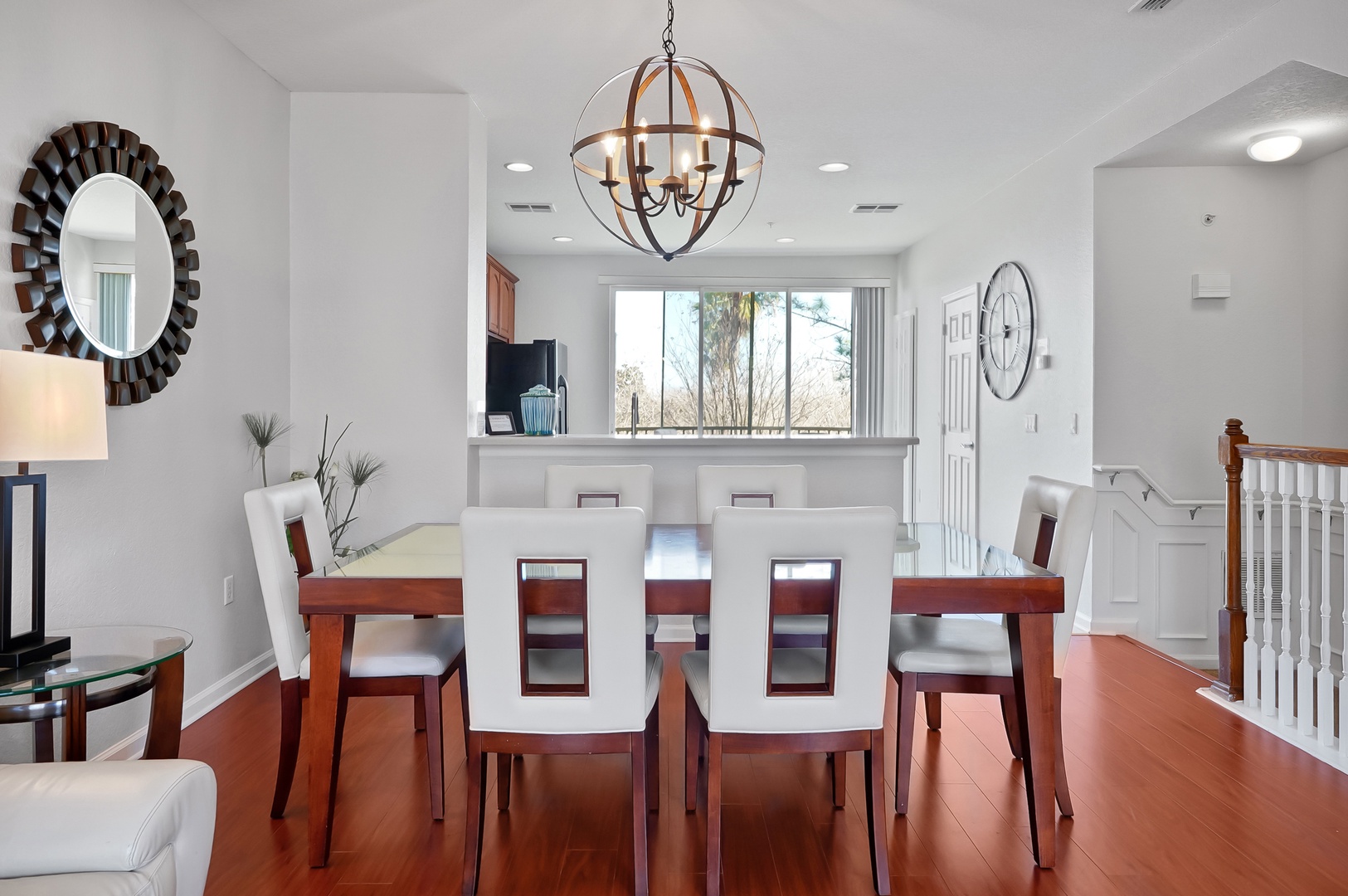 Gather around your elegant dining table beneath the statement chandelier for memorable meals with loved ones.