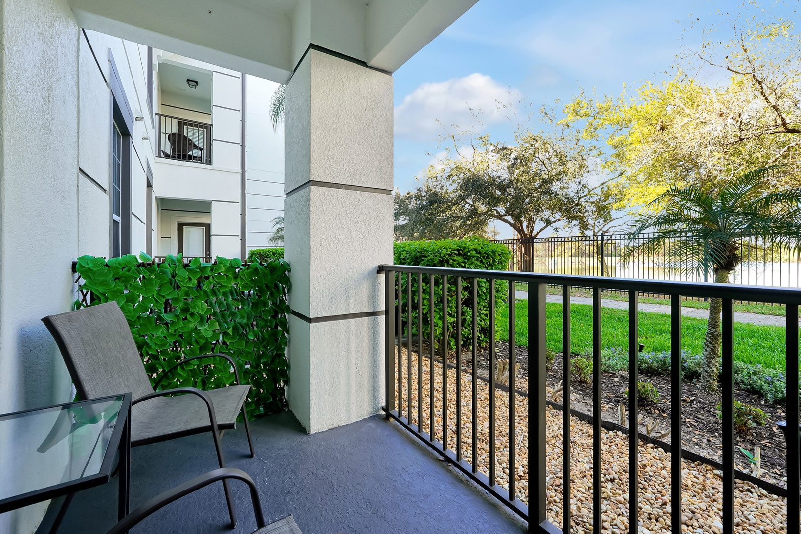 Your private balcony offers peaceful garden views with comfortable seating to unwind after exploring the area.