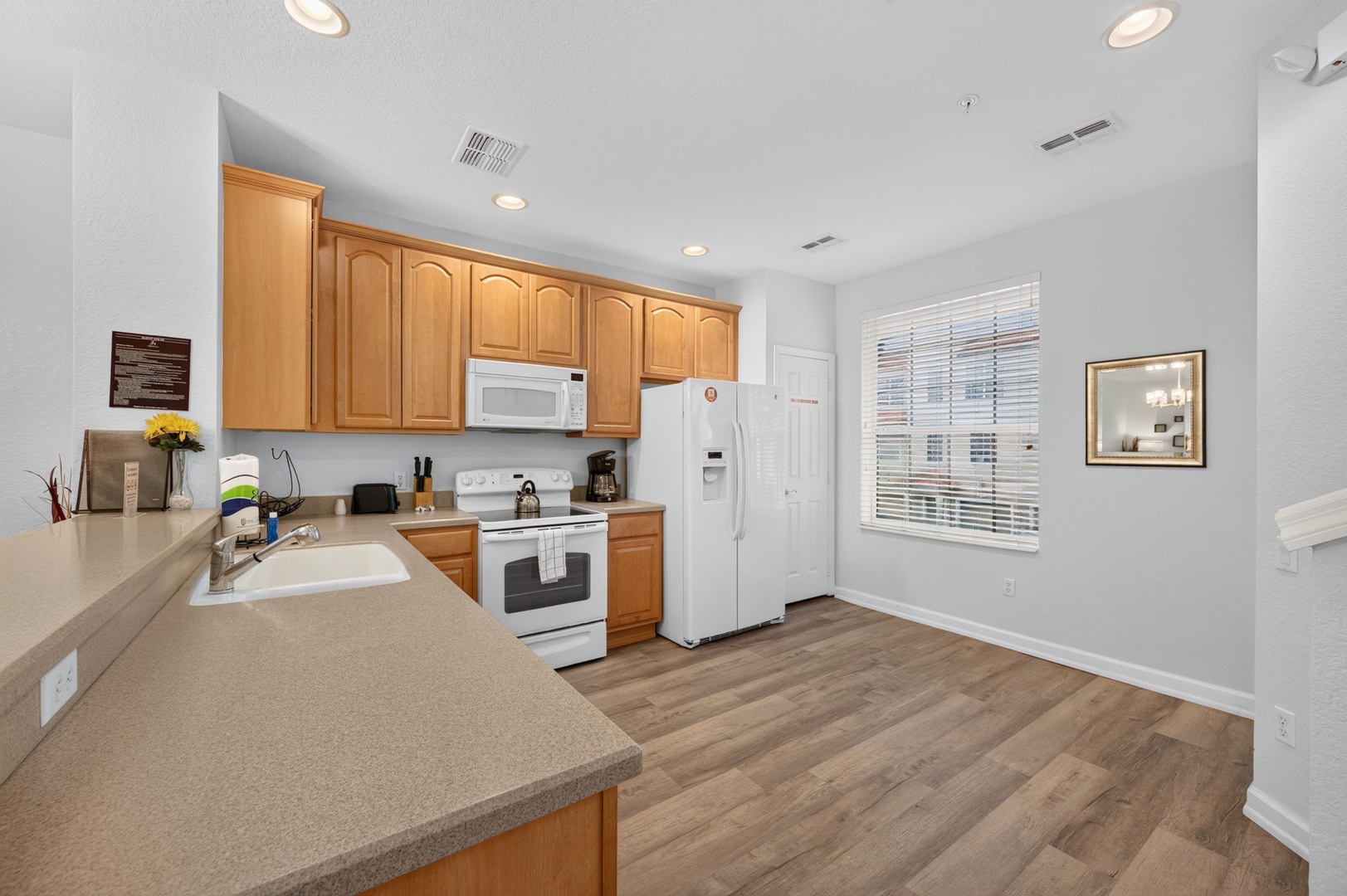 Step into your fully equipped kitchen with plenty of counter space, modern appliances, and warm natural light streaming through the windows—perfect for preparing your favorite meals.
