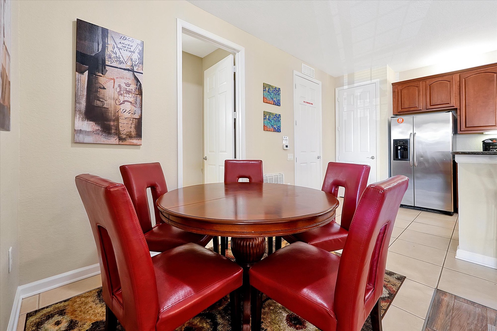 Gather around your elegant dining table for memorable meals together in this stylish space with rich red leather seating.