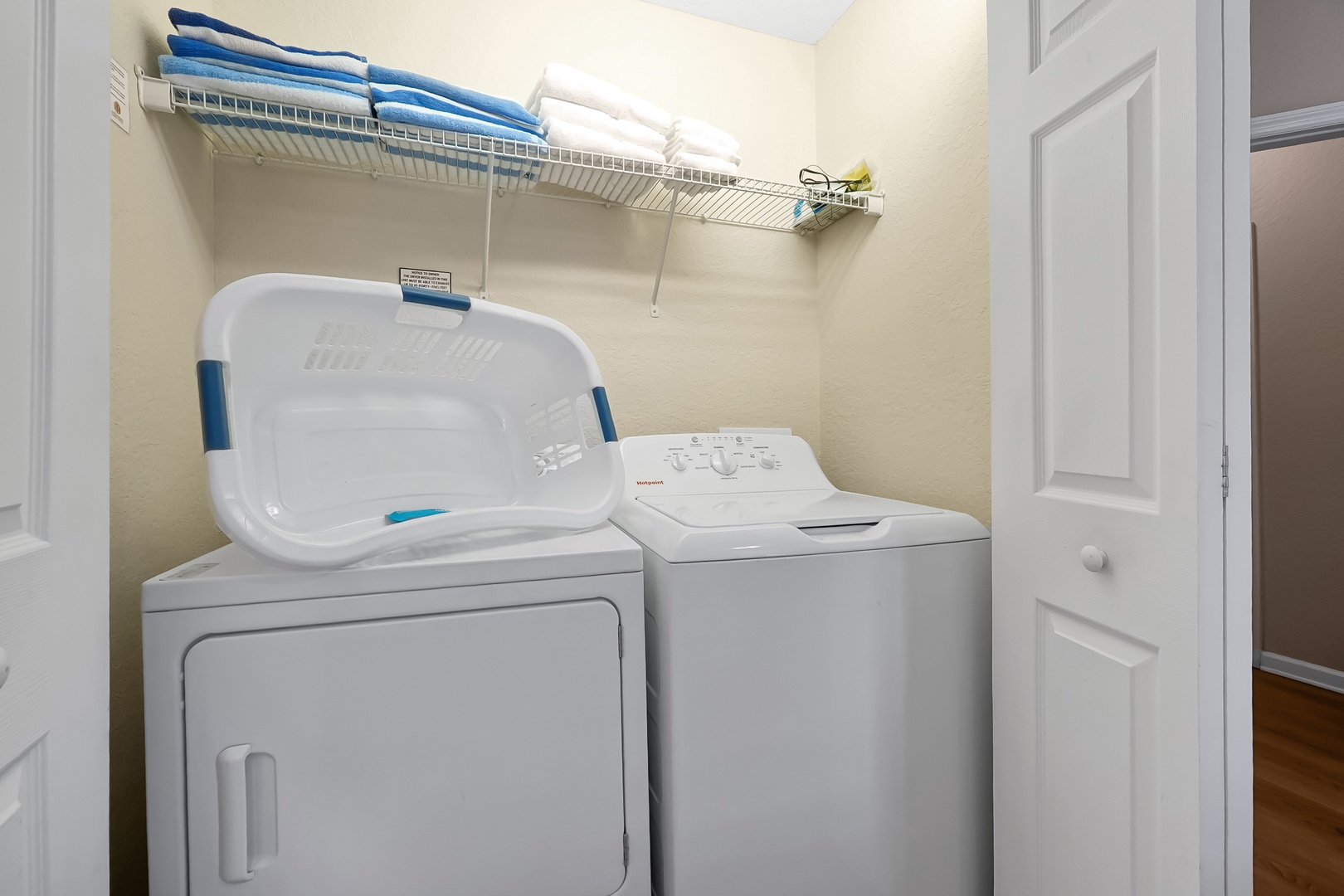 Your in-unit laundry room keeps your clothes fresh throughout your stay, with convenient storage above for towels and supplies.