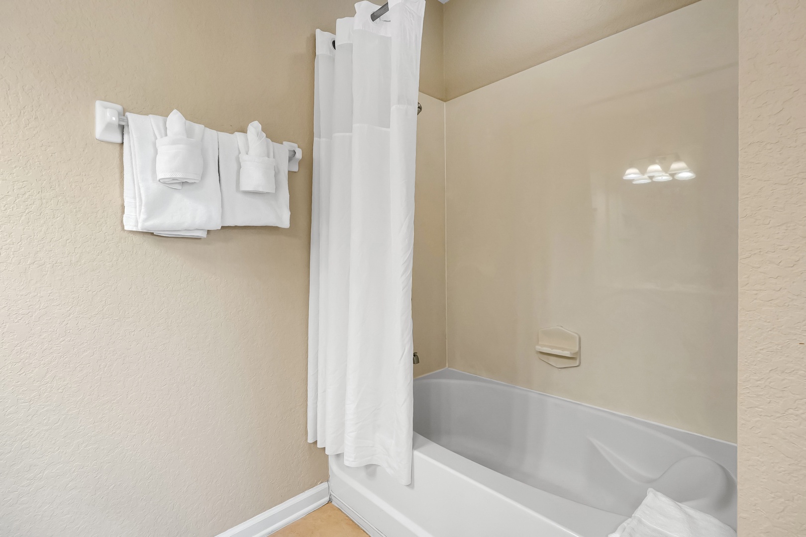 Unwind after your day in this pristine bathroom, complete with a spacious tub-shower combo and fresh towels waiting for you.