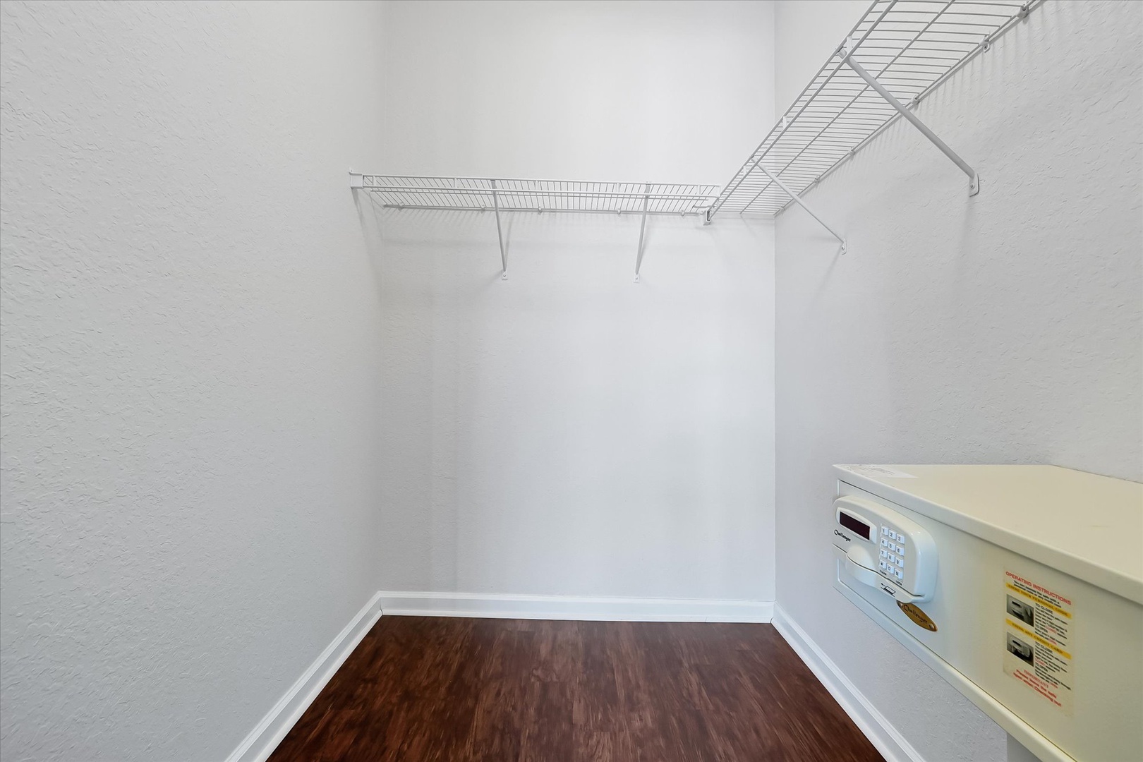 Your spacious walk-in closet features ample wire shelving and a convenient washer-dryer combo, making extended stays effortless.