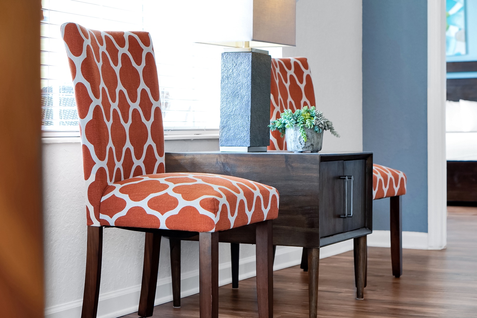 Bright patterned chairs and modern decor create a welcoming spot to relax or enjoy a meal together.