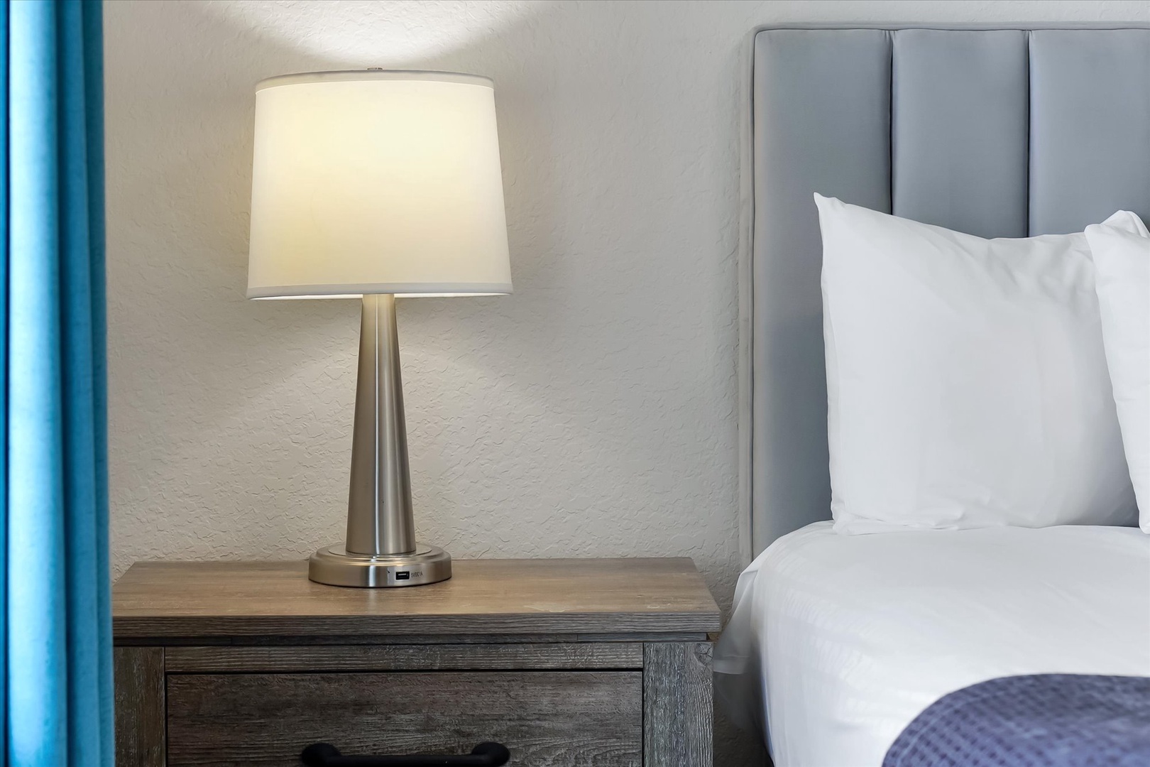 Sink into crisp white linens beside your elegant bedside lamp - perfect for late-night reading in your peaceful retreat.