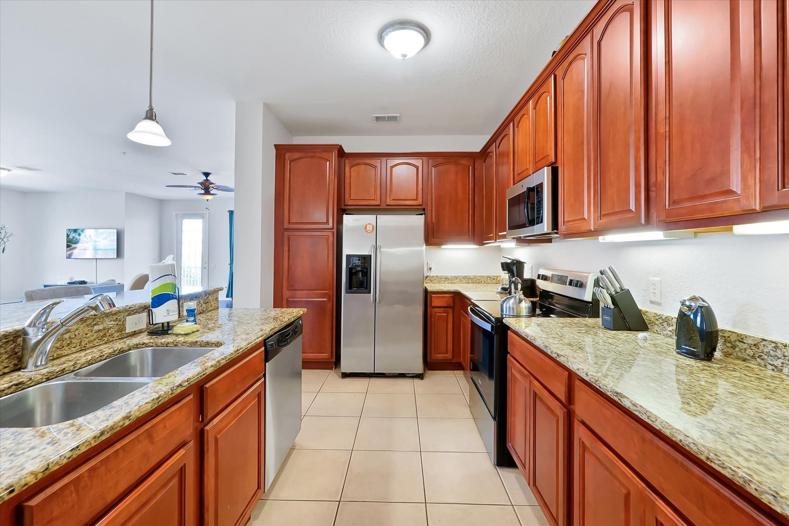 Your gourmet kitchen features rich cherry cabinets, granite countertops, and stainless steel appliances, perfect for preparing memorable meals during your stay.