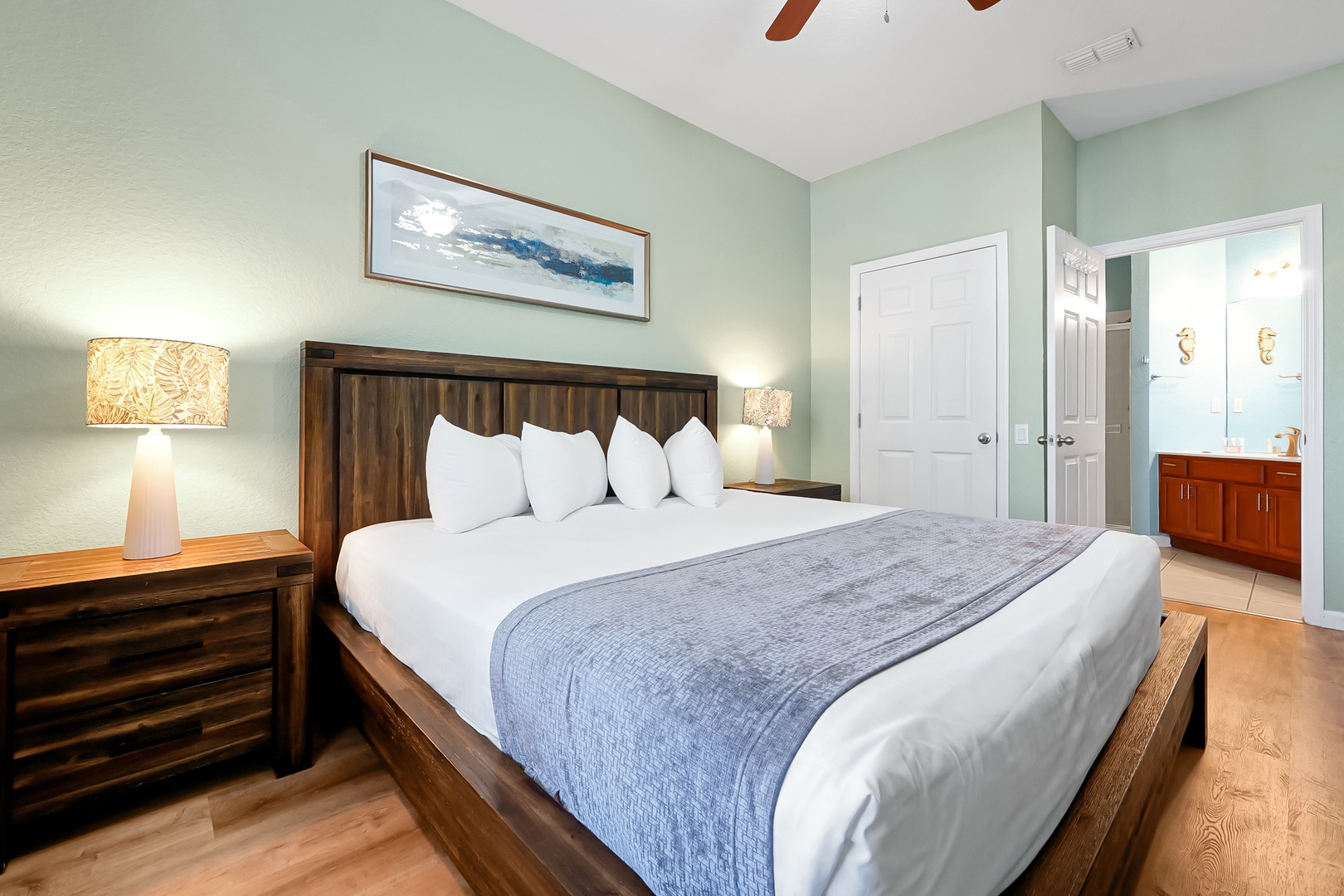 Unwind in your serene bedroom sanctuary with calming mint walls, plush bedding, and warm wood accents creating the perfect retreat.