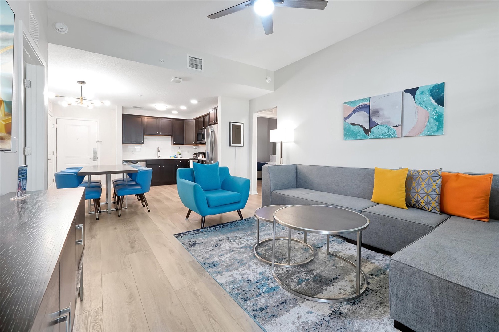 Your bright open-plan living space blends comfort with style, featuring a modern kitchen and cozy seating perfect for unwinding.