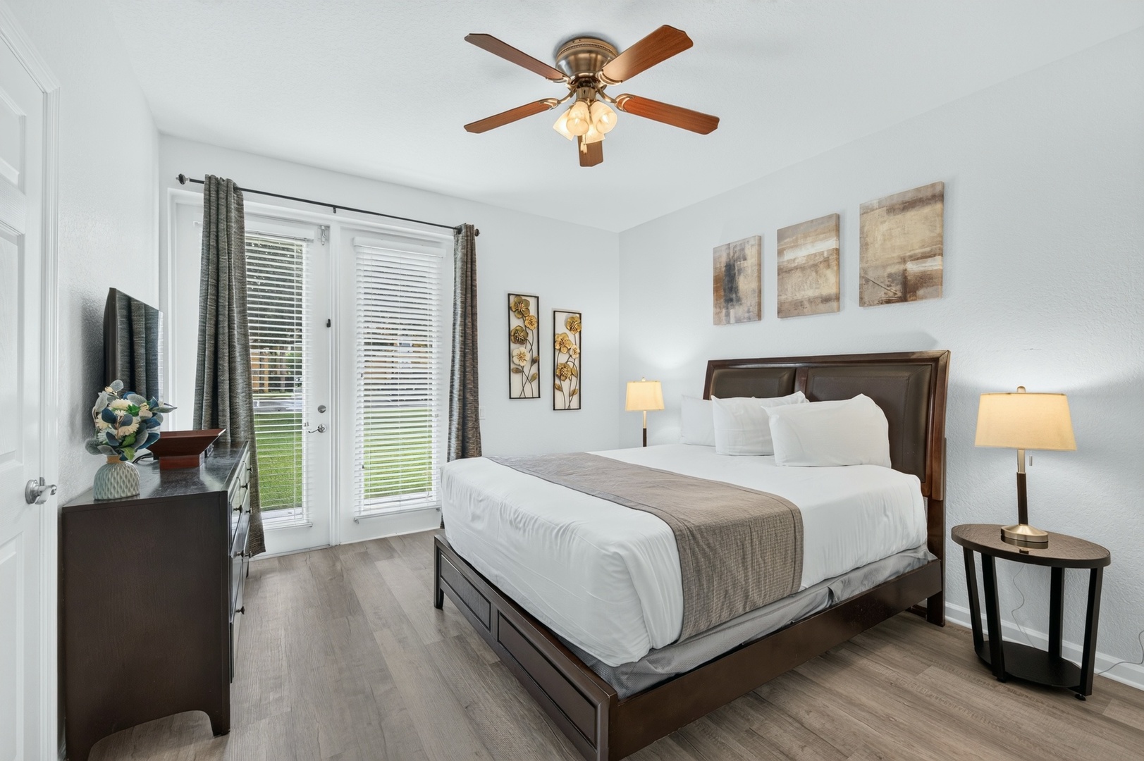 Sink into your comfortable bed after a day of adventure. Natural light fills your room through French doors, while the ceiling fan keeps the space cool and inviting.