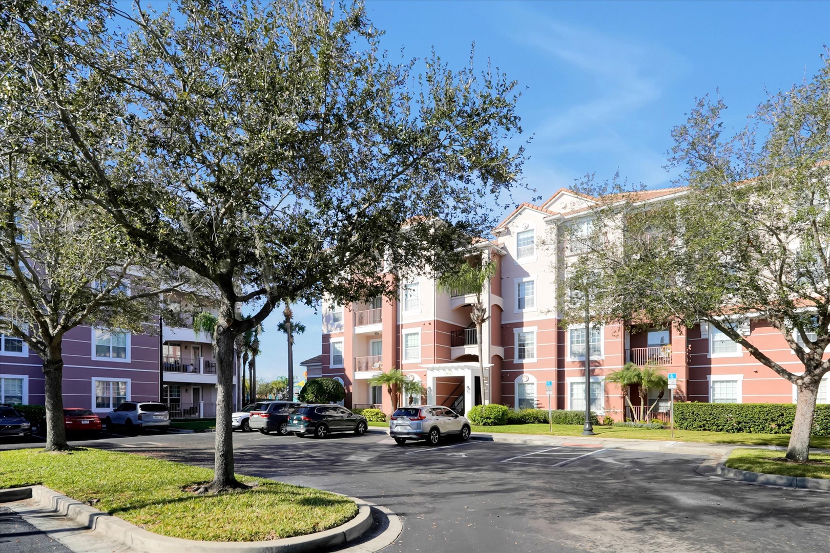 Modern apartment complex with convenient parking and landscaped grounds in a quiet residential setting.