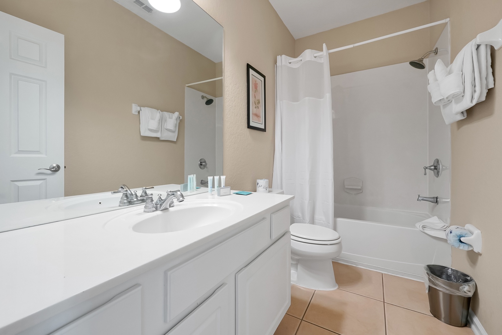 Your private bathroom features a spacious tub-shower combo, vanity with ample counter space, and fresh towels ready for your stay.