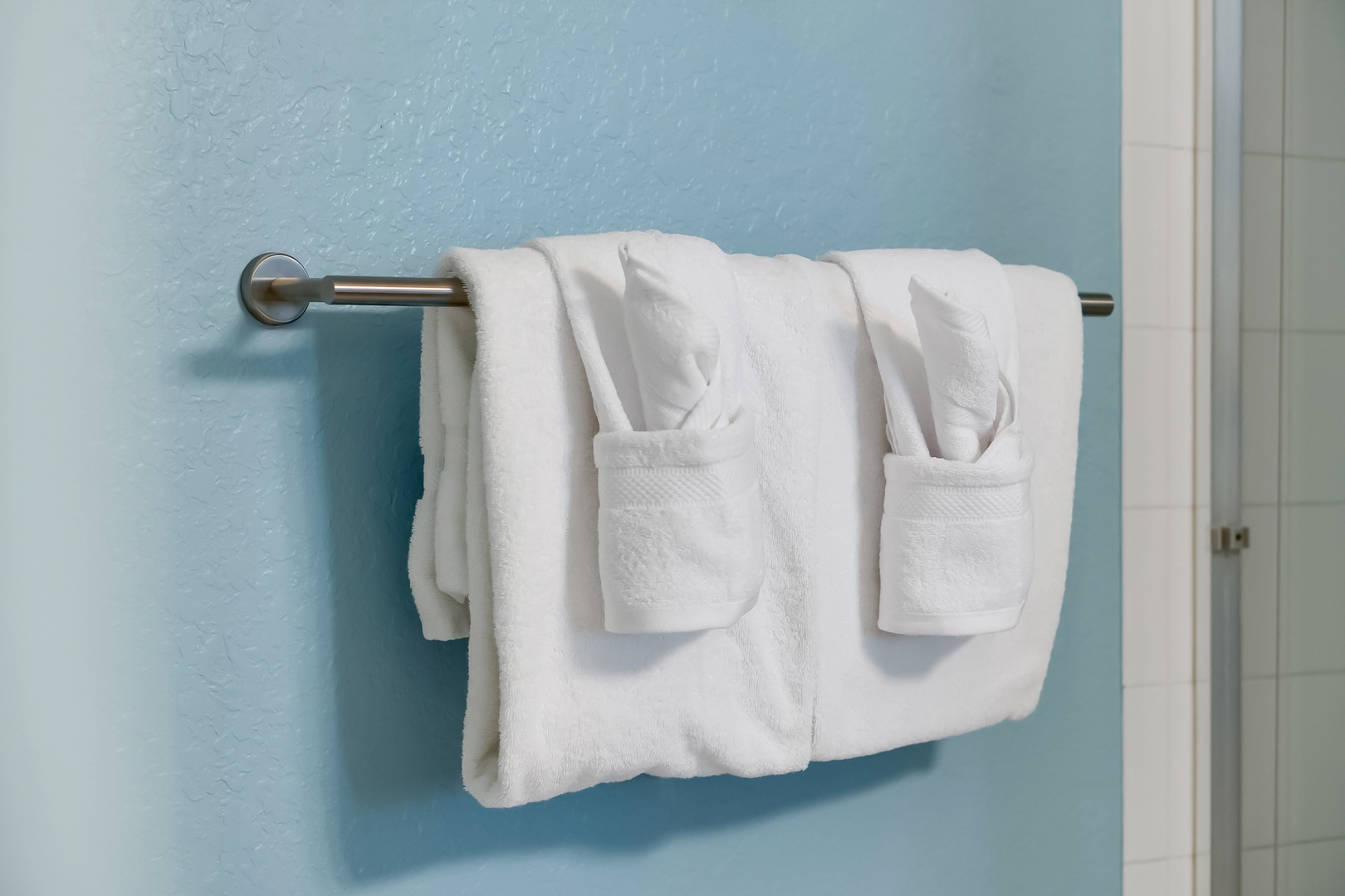 Plush white bathrobes await you, perfectly arranged for your comfort after a relaxing soak or shower.