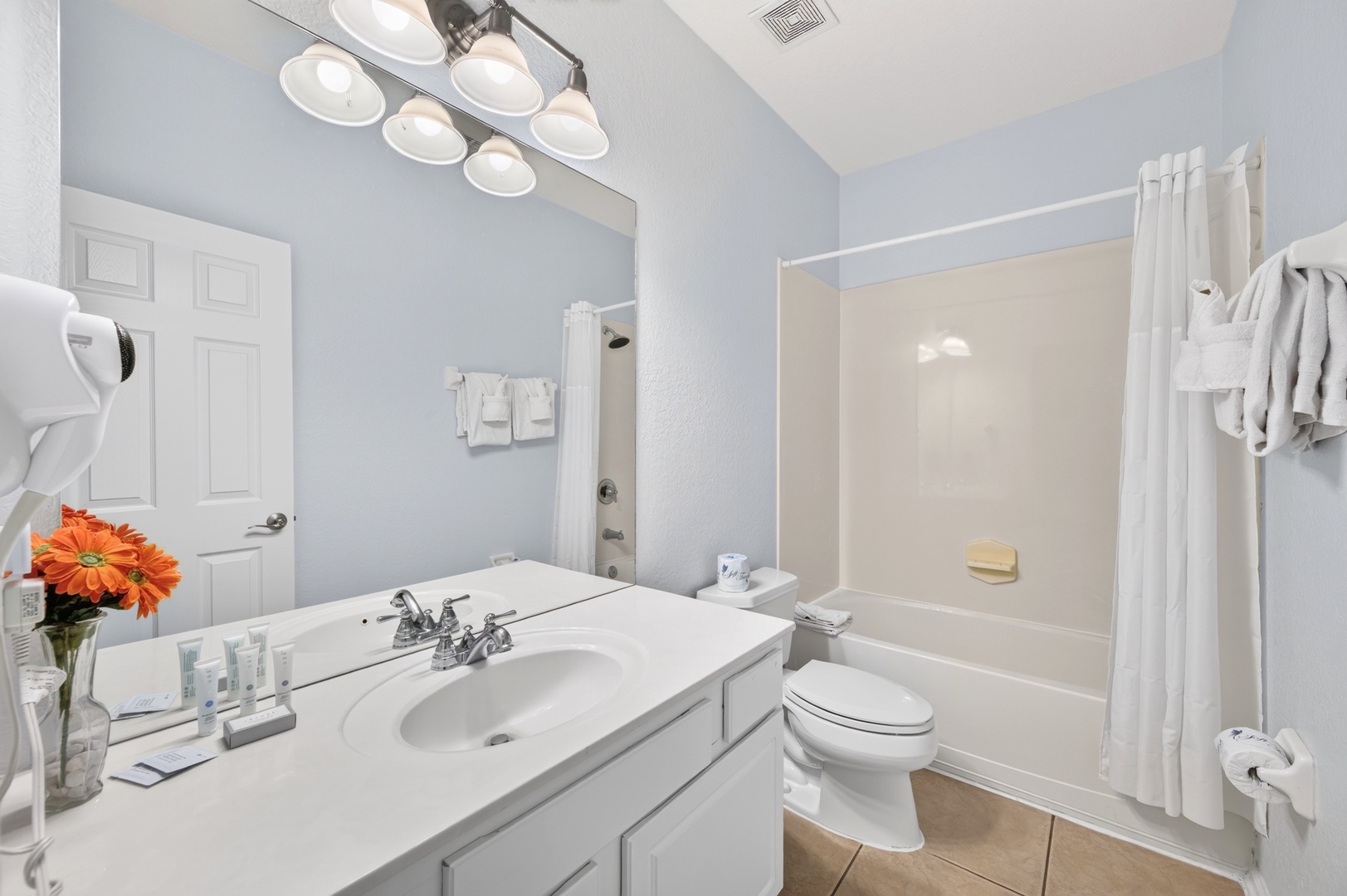 Step into your bright, sparkling bathroom where fluffy towels and a deep soaking tub await. The crisp space offers all the essentials for a refreshing start or a relaxing evening unwind.