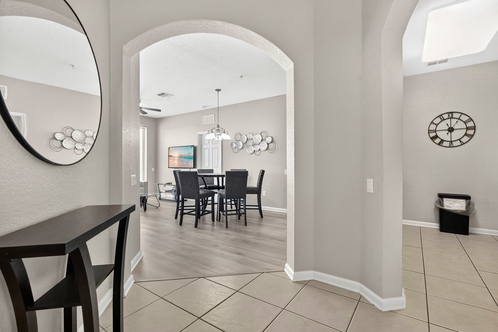 Step into your elegant dining space with archway details and modern furnishings perfect for memorable meals together.