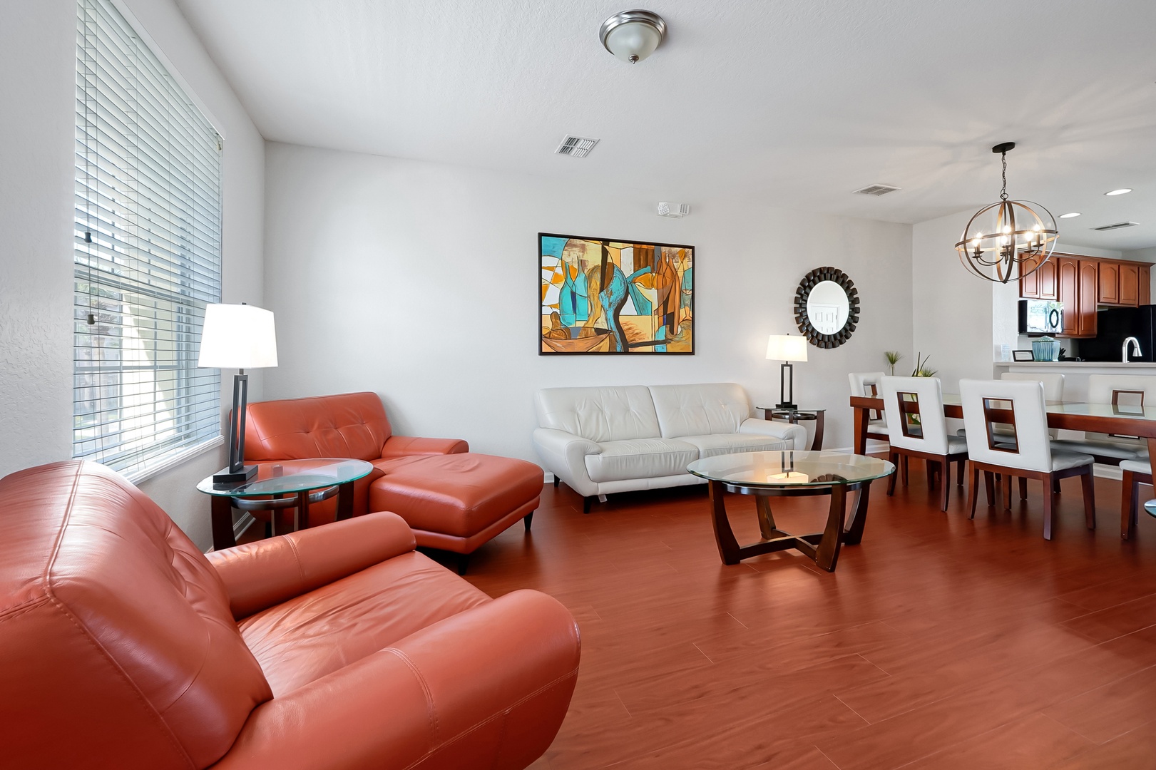 Relax in your open-plan living space with leather seating, modern art, and a full kitchen perfect for family meals.