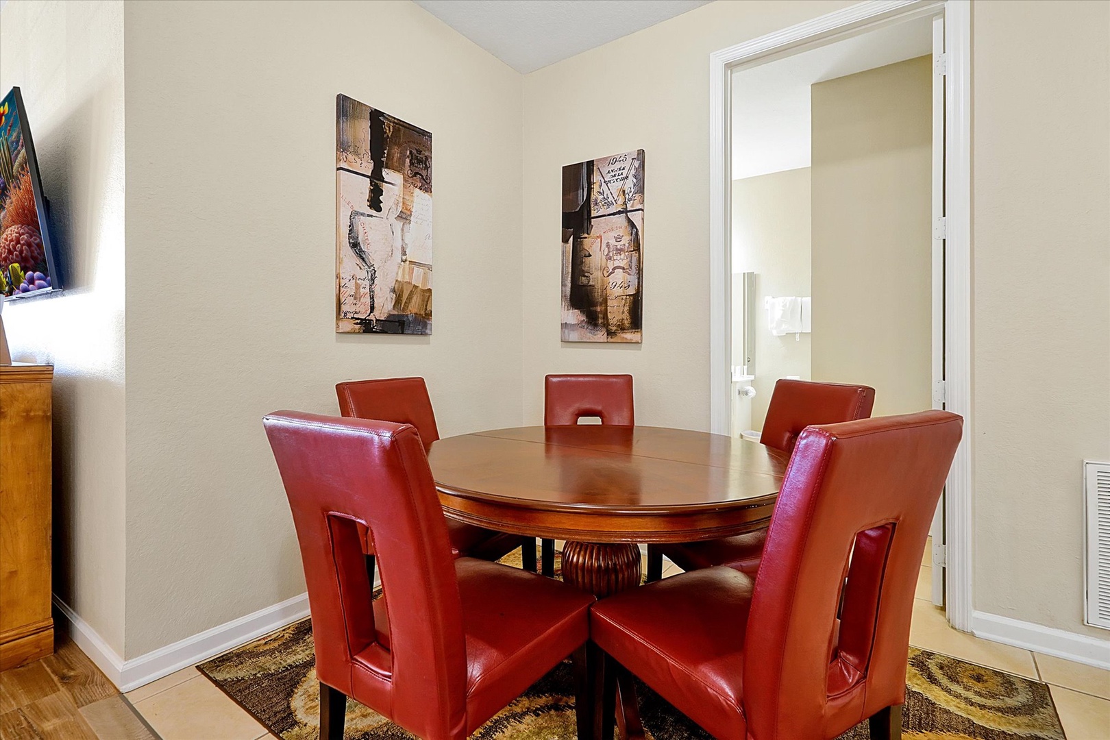 Gather around your elegant dining table with rich red leather chairs - perfect for memorable meals and conversations in this sophisticated space.
