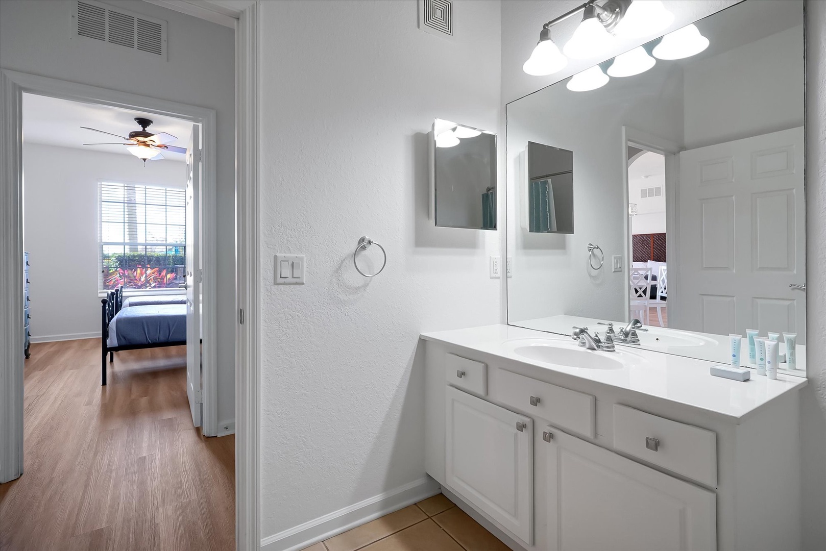 Your bright ensuite bathroom connects seamlessly to the bedroom, featuring a spacious vanity with ample storage and excellent lighting for getting ready.