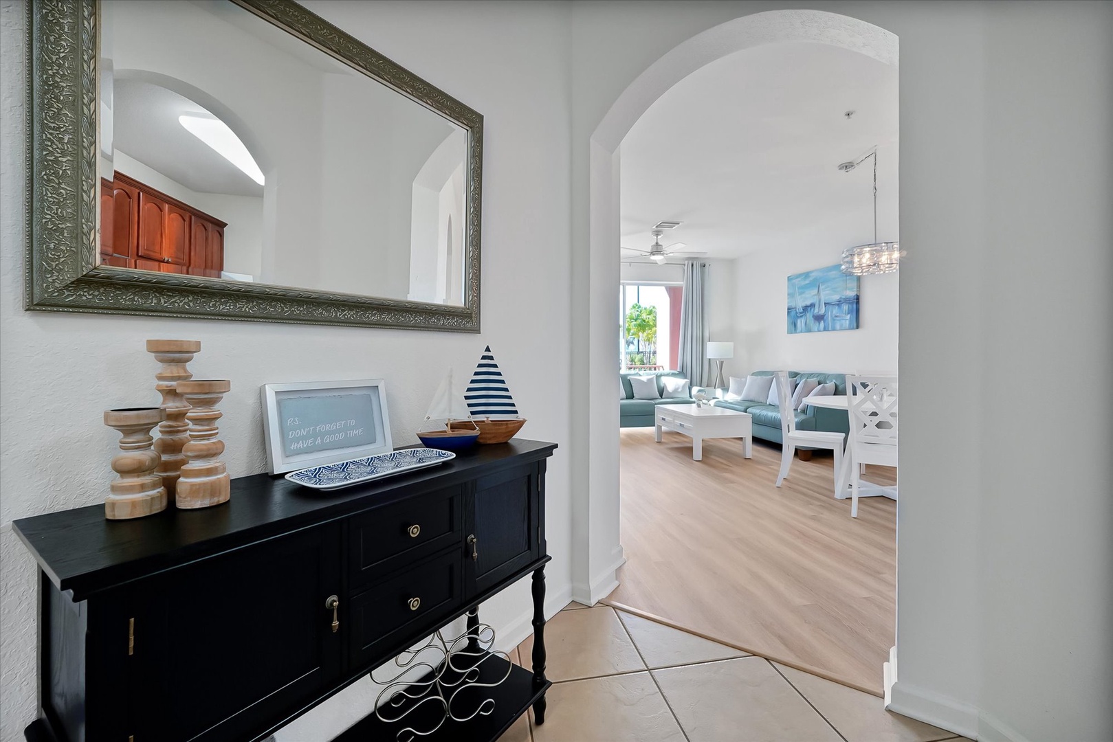 Your welcoming entry features elegant archways that frame the bright, airy living space beyond, creating an immediate sense of Mediterranean charm.