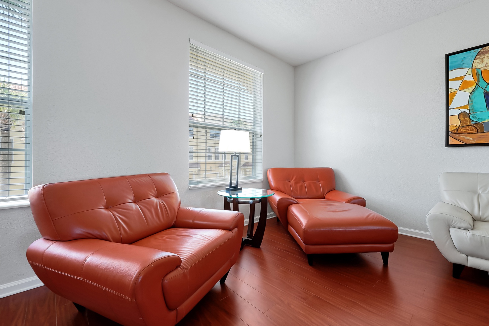 Settle into your stylish living room featuring rich leather seating and warm wood floors that create the perfect atmosphere for relaxation.