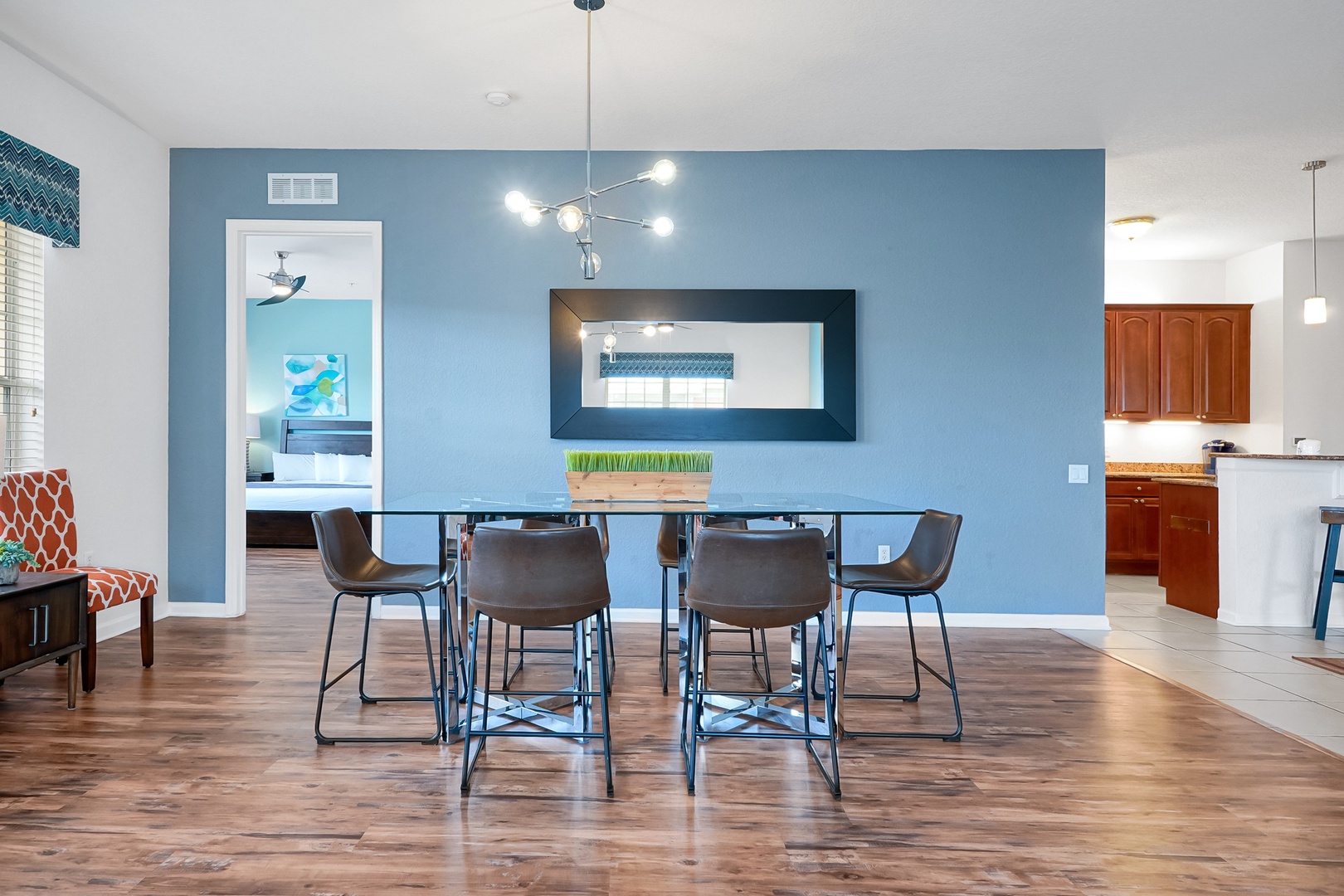 Gather around this inviting dining space where your group can share meals and stories together. The modern table seats six comfortably, with warm wood floors and calming blue tones creating the perfect backdrop for your vacation memories.