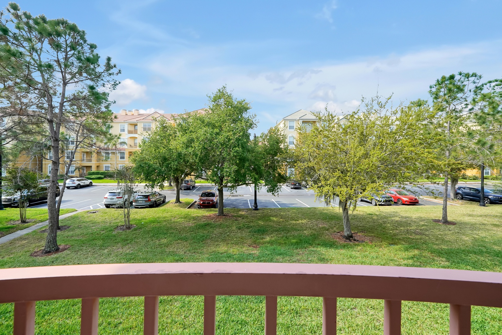 This apartment complex features well-maintained grounds with mature trees and convenient parking throughout the residential area.