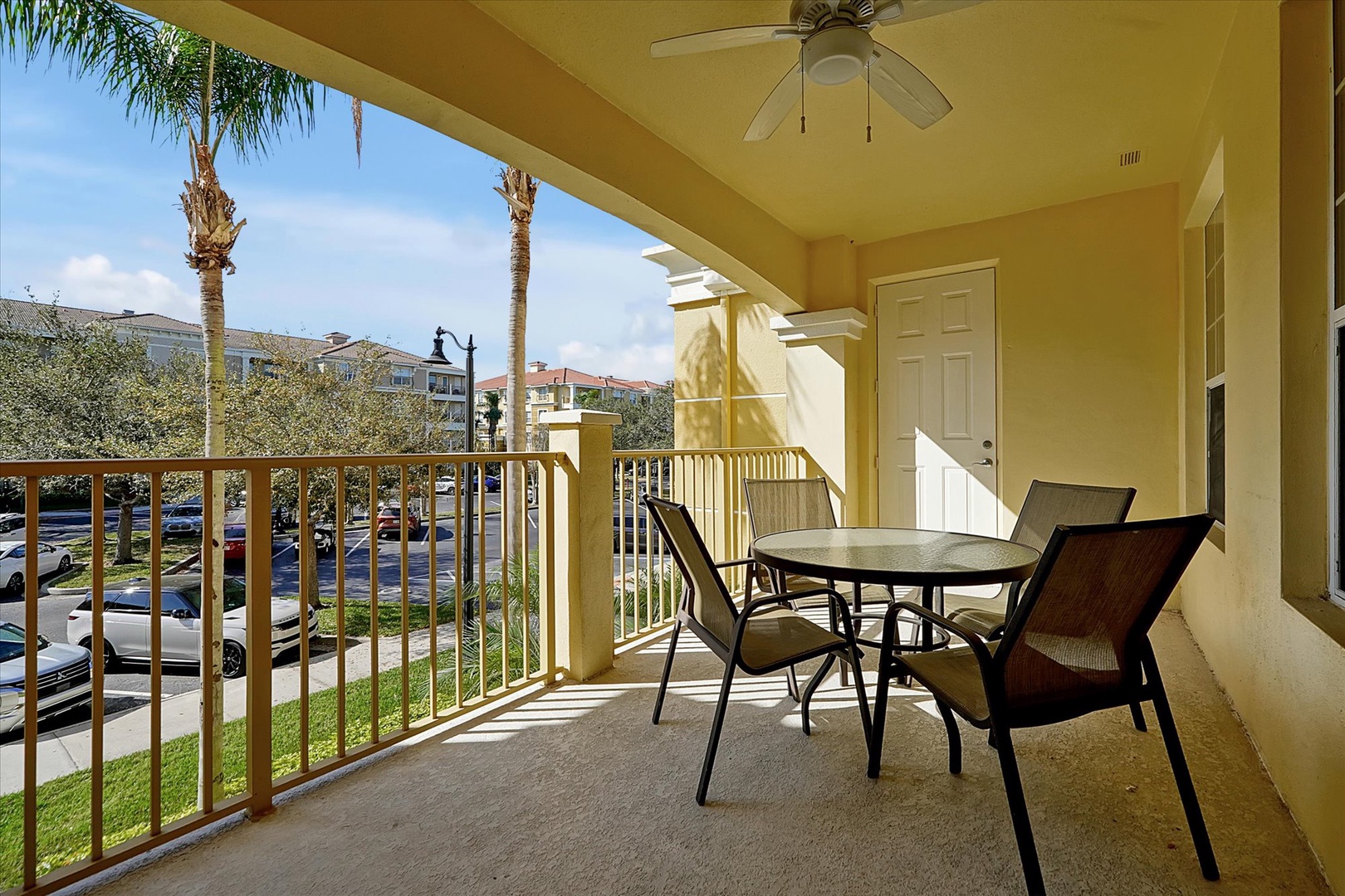 Relax on your private balcony with morning coffee and gentle breezes, enjoying tropical palm views from your outdoor dining space.