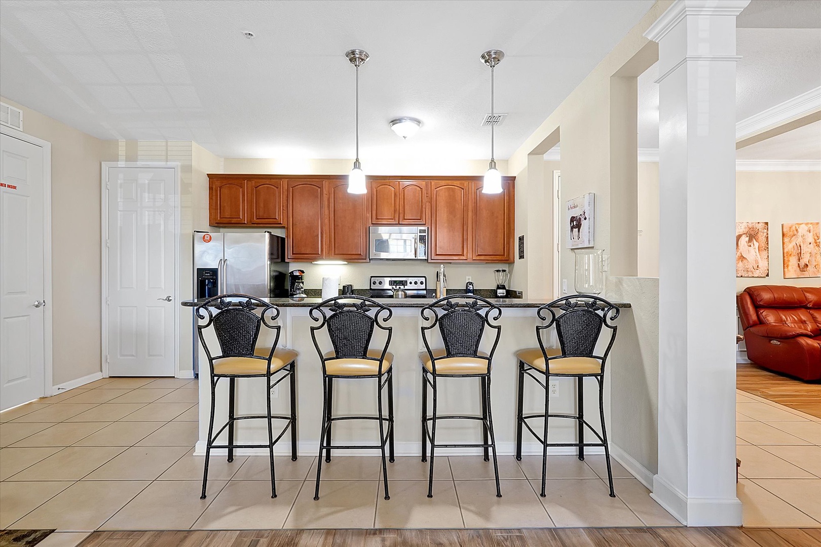 Your open kitchen features rich wood cabinets, modern appliances, and a stylish breakfast bar where you can enjoy morning coffee.