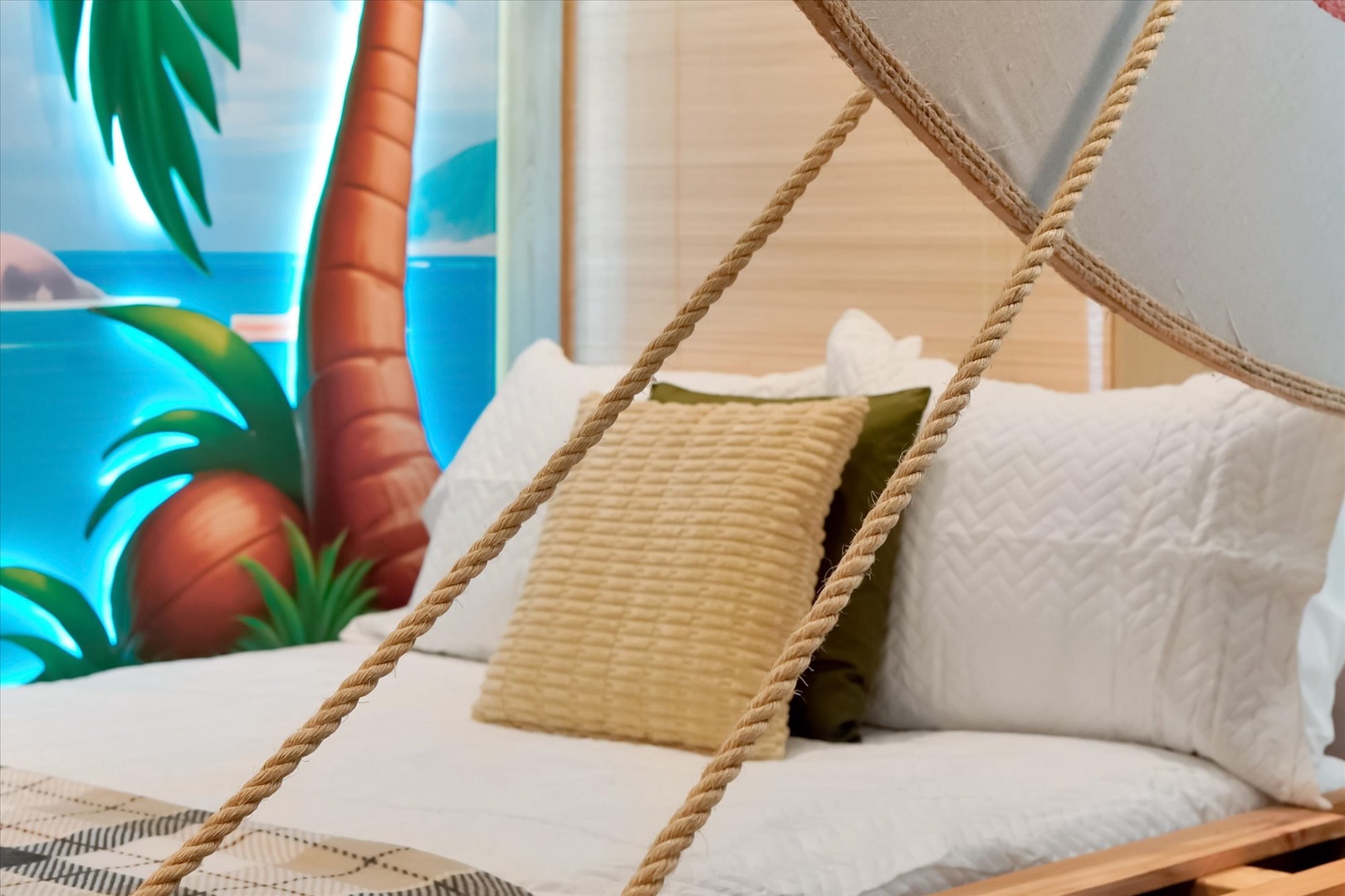 Sink into soft linens and let the tropical artwork whisk you away to island dreams. Your personal hammock-style canopy adds a playful, beachy vibe to your restful retreat.