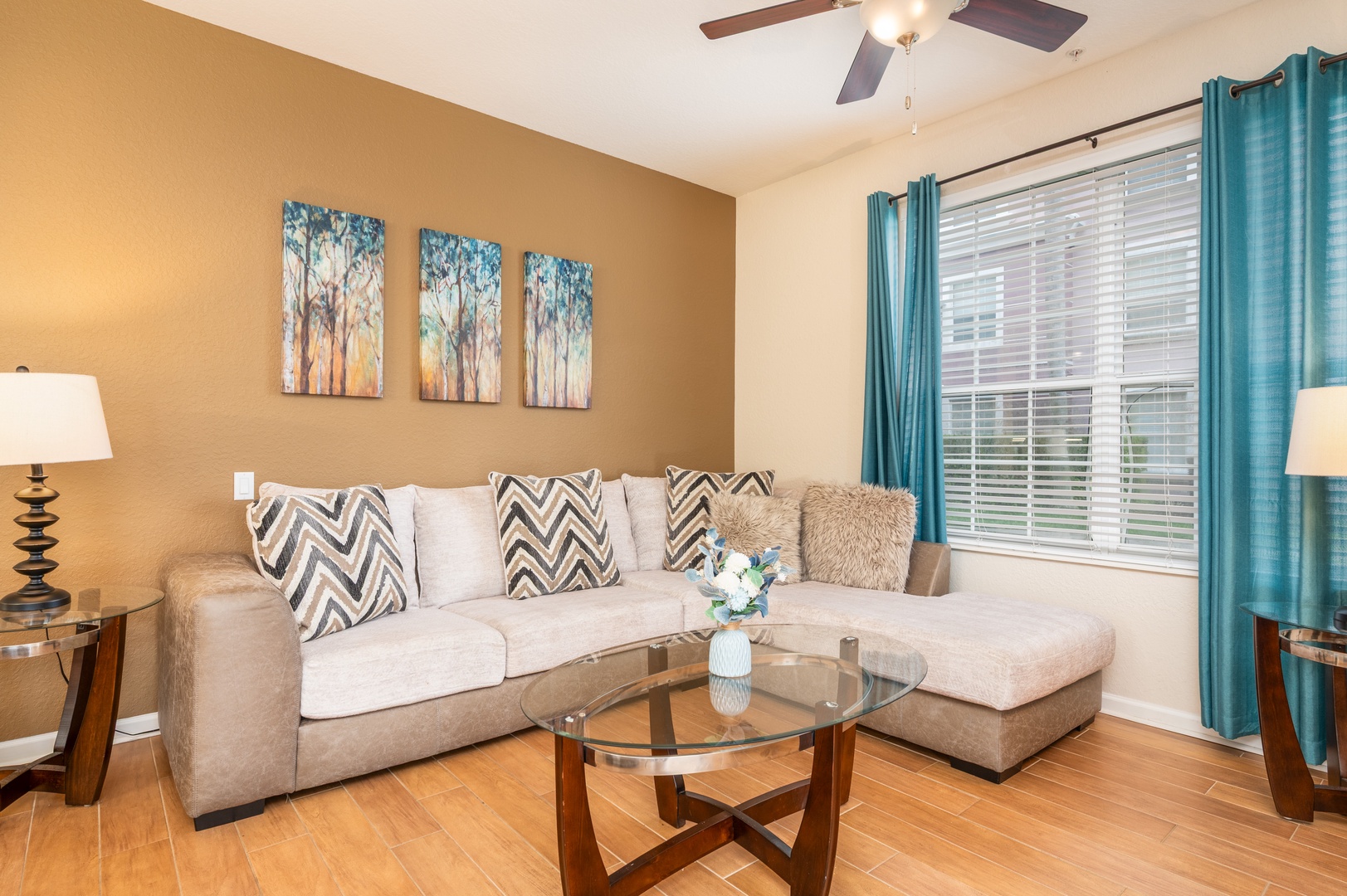 Your cozy living room features comfortable seating, stylish decor, and natural light streaming through large windows.