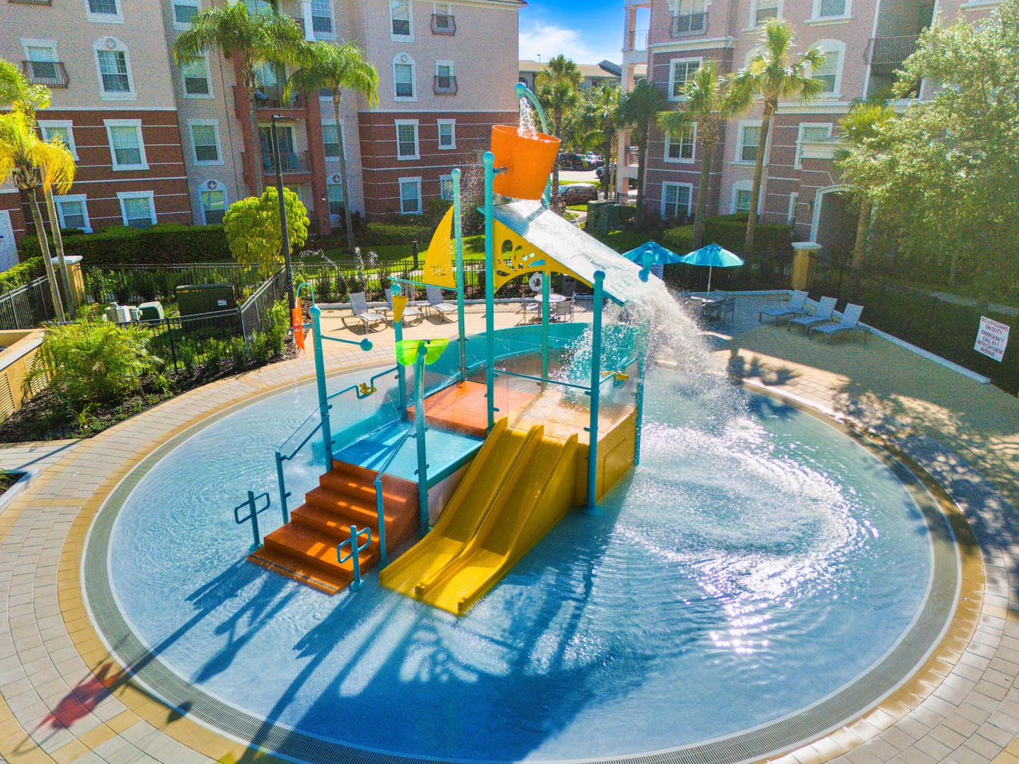Colorful water playground with slides, splash features, and tipping bucket creates endless fun for your little ones.