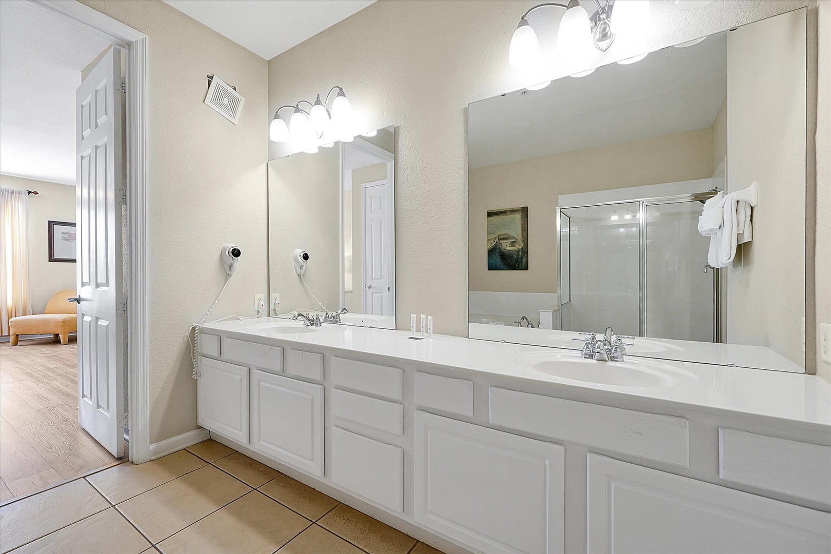 Enjoy spacious double vanities with ample counter space and bright lighting for your morning routines.