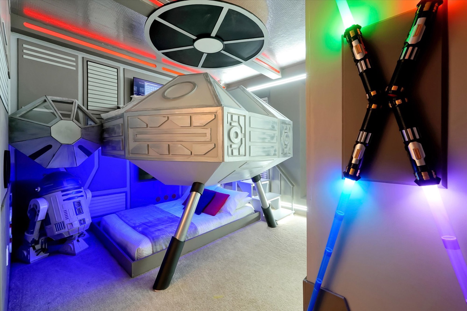 Step into a galaxy far, far away in this epic Star Wars-themed bedroom with glowing lightsabers, spaceship bunk beds, and immersive cosmic lighting for an unforgettable adventure.