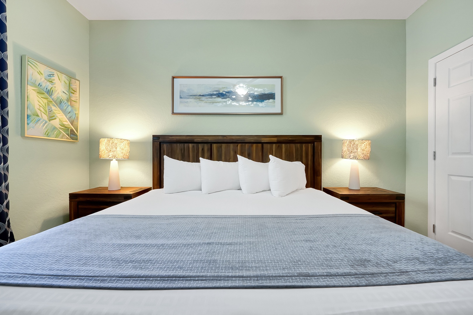 Sink into this plush king bed with soft linens and warm lighting, creating your perfect sanctuary for restful nights.